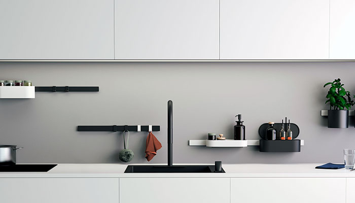 Hvidt køkken med sort køkkenvask og vægopbevaring